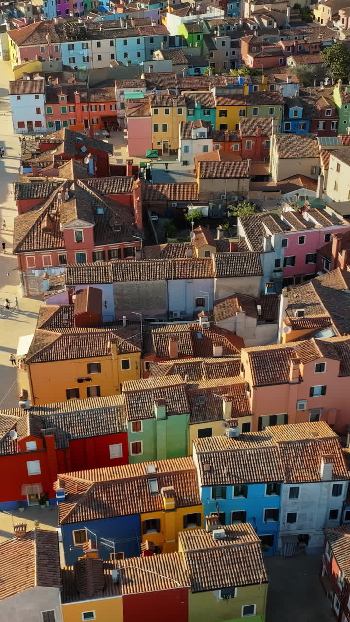 Aerial drone view of the colourful houses of Burano Island, Italy. Vertical