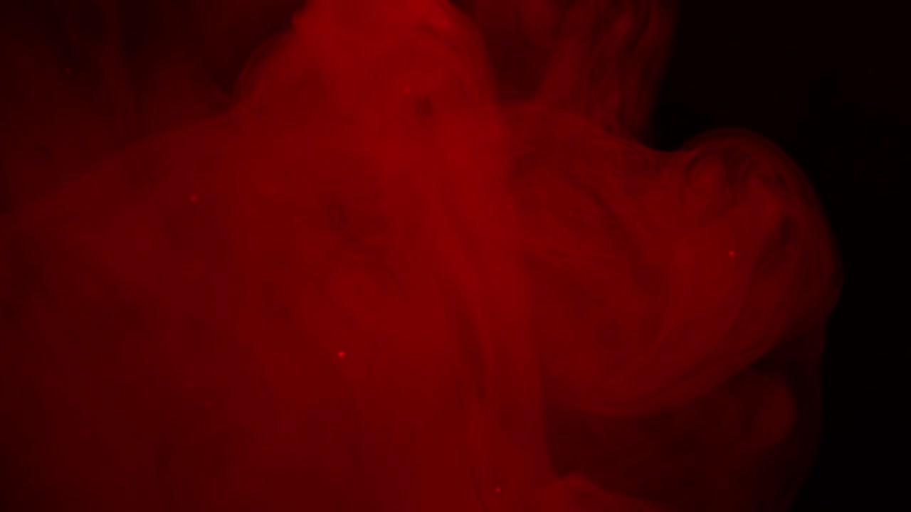 Vortici e particelle di fumo rosso astratto.