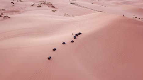 Adventure-in-Desert,-ATV-Quad-Group-on-Top-of-Sandy-Hill-in-Coral-Pink-Sand-Dunes-State-Park,-Utah-USA,-Aerial-View