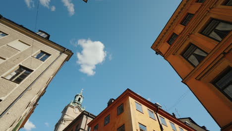 st nicholas (storkyrkan) bell tower in stockholm view through a narrow street with old houses 4k vid