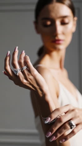 elegant woman showcasing jewelry and hands