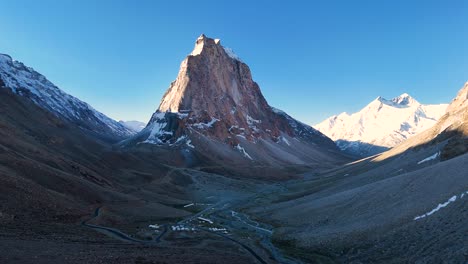 aerial drone shot of gumbok rangan’s rugged terrain glowing under the early morning sun.