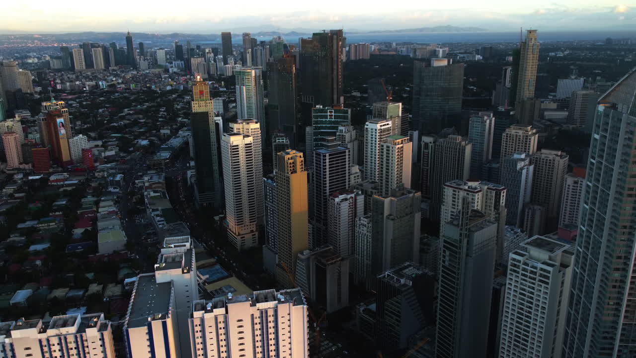 Aerial view tilting toward the Buendia ave, sunset in Makati, Manila, Philippines