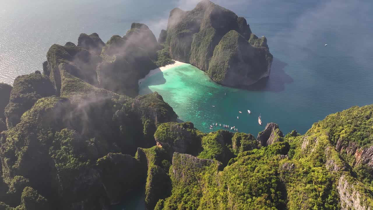 Stunning view of famous Maya Bay, over fog. Travel destination in Thailand, drone panoramic.