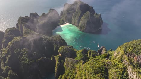 stunning view of famous maya bay, over fog. travel destination in thailand, drone panoramic.