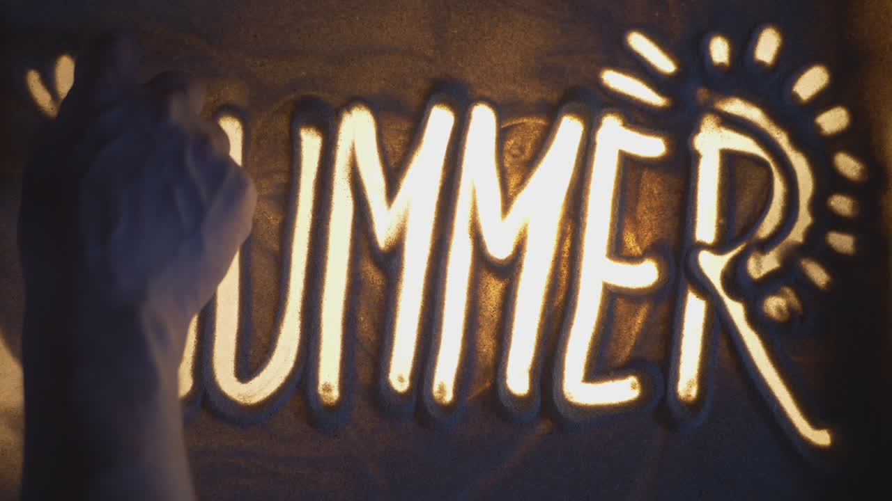 Sun Rays On A SUMMER Inscription. Sand On Illuminated Glass