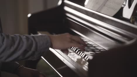 close up of young man playing piano in all by himself