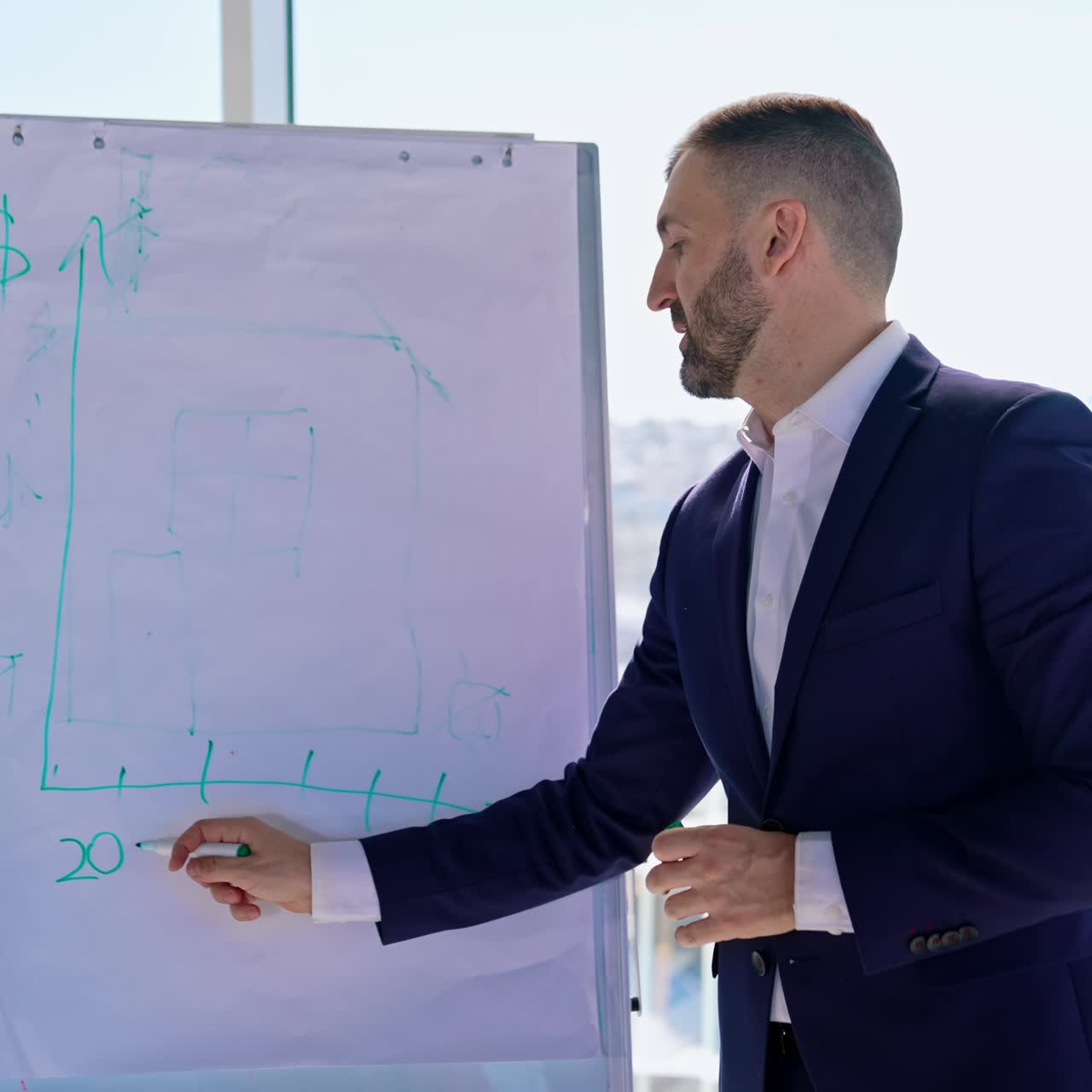 Businessman making notes with a marker. Successful entrepreneur writing on a board in the office center on the background of the window. Planning business
