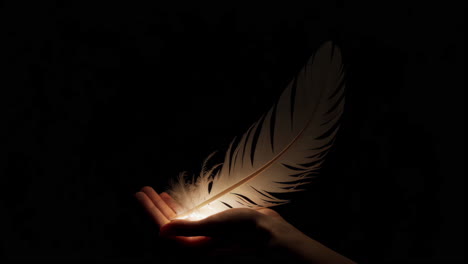 glowing feather held in a hand