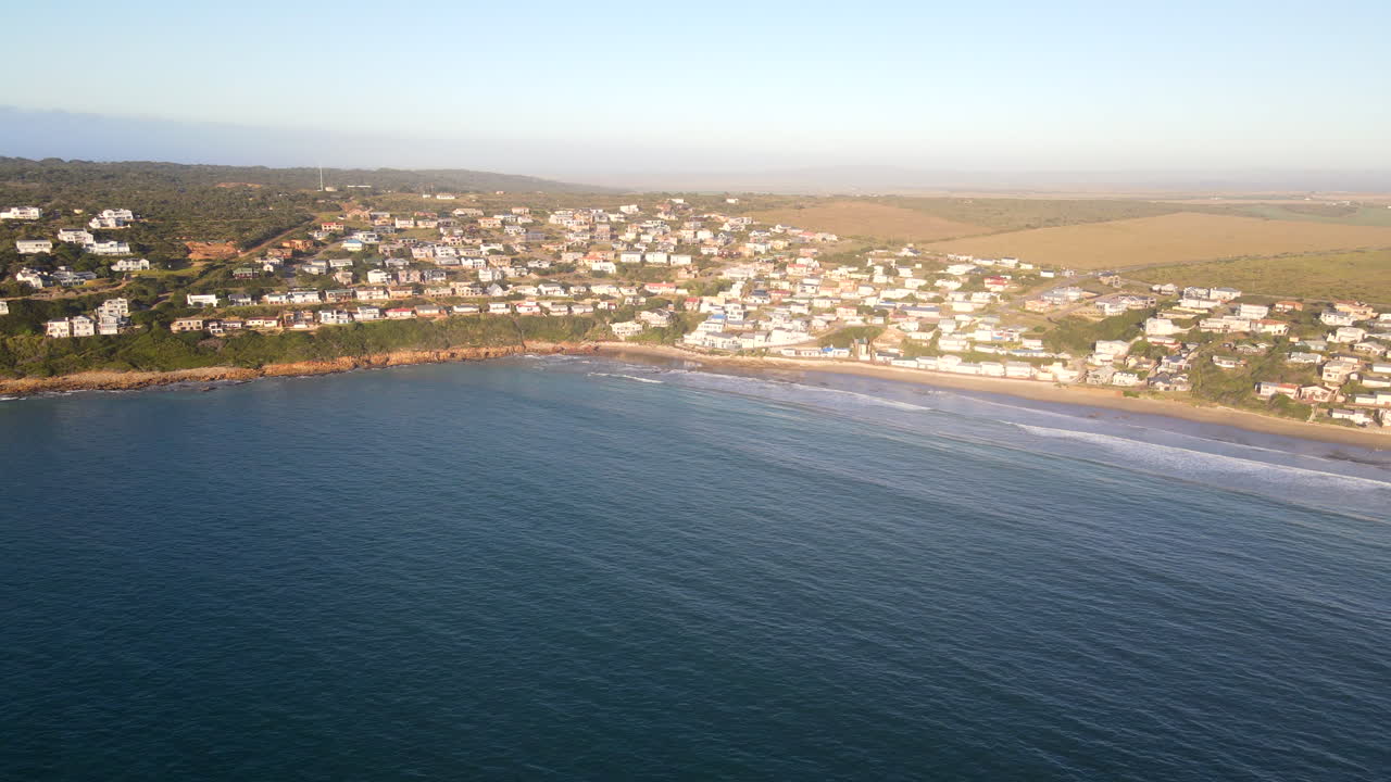 Sunrise drone tilt-up reveals scenic holiday town Vleesbaai near Mossel Bay