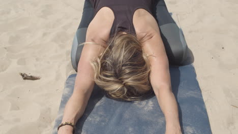 close up of woman in sleeping swan yoga pose