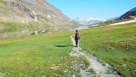 backpacker trekking on the alps