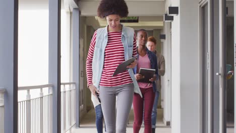 diverse group of male and female business colleagues walking through corridor