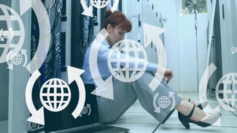 Animation-of-globes-with-arrows-over-caucasian-woman-in-server-room