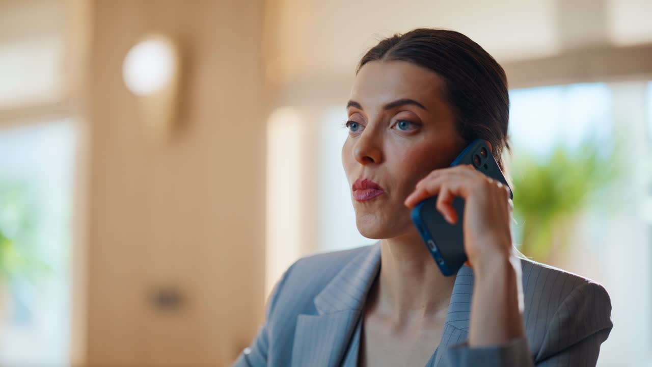 Resting brunette speaking mobile phone waiting meeting in modern cafe closeup