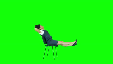 Attractive-woman-witting-on-chair-with-legs-up-and-hands-behind-head