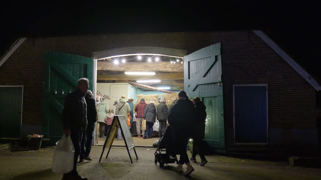 People visiting a barn market at night