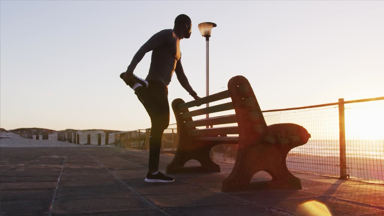 Man exercising outdoors near mountains and by the sea