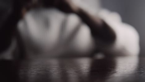 black man hands picking wireless airpods in shallow focus on the table