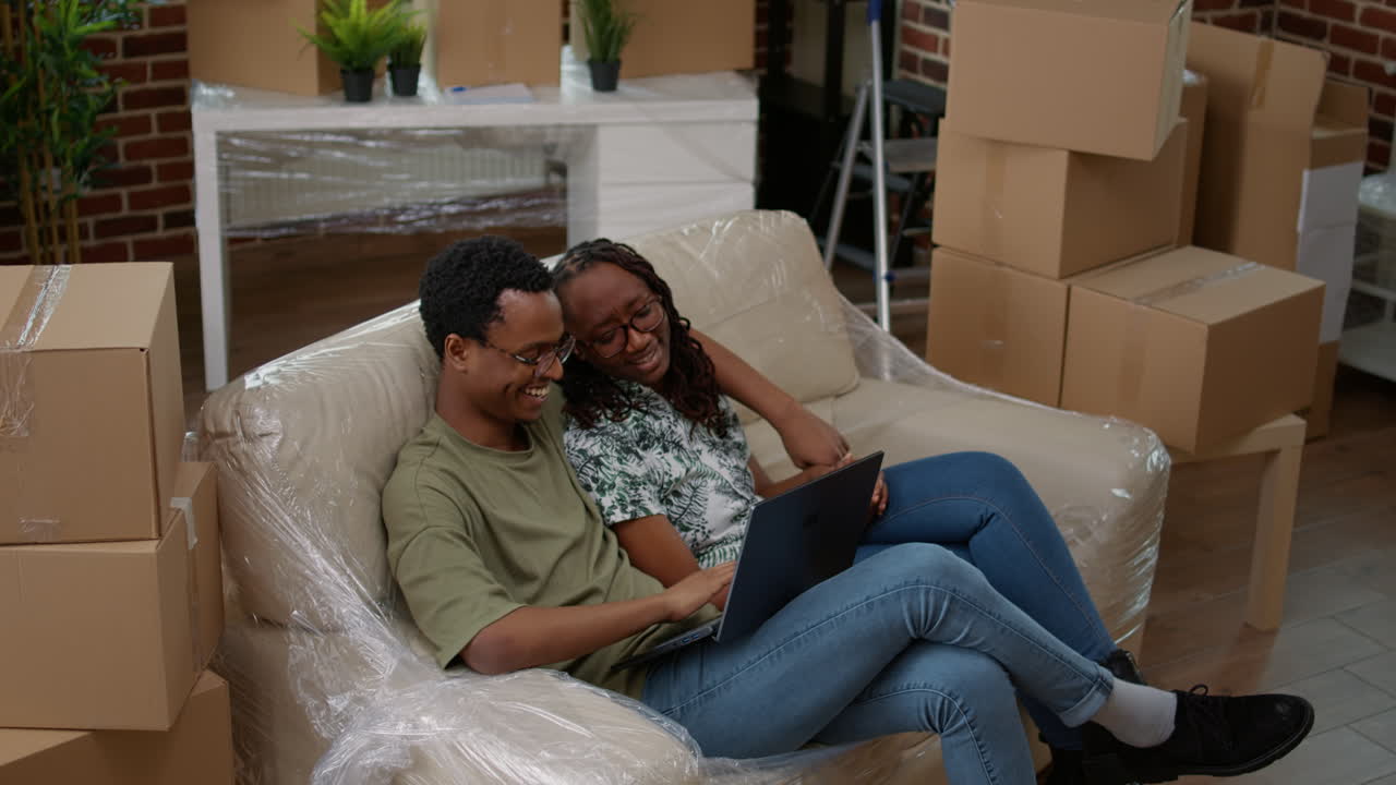 Husband and wife doing online shopping for home decor