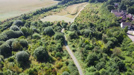 Residential-forest-area-with-bat-field-at-Suffolk,-England---aerial-drone-shot