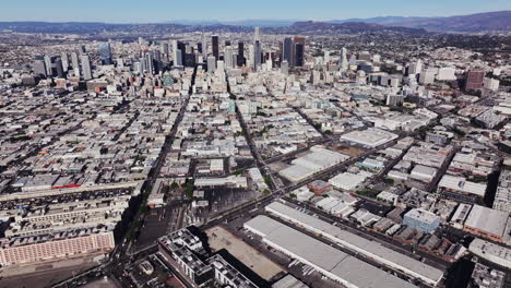 panoramic aerial view of downtown los angeles cityscape with surrounding urban sprawl