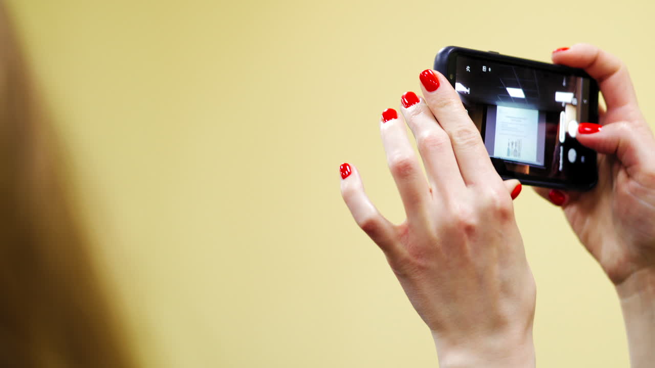 Woman taking photo at conference. Close up view of woman hands taking photo at conference