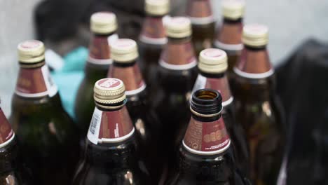 glass beer bottles stacked ready for recycling