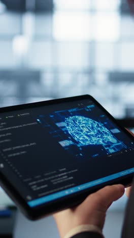 vertical video data center technician using artificial intelligence on tablet, close up