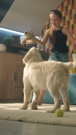 girl playing with a puppy