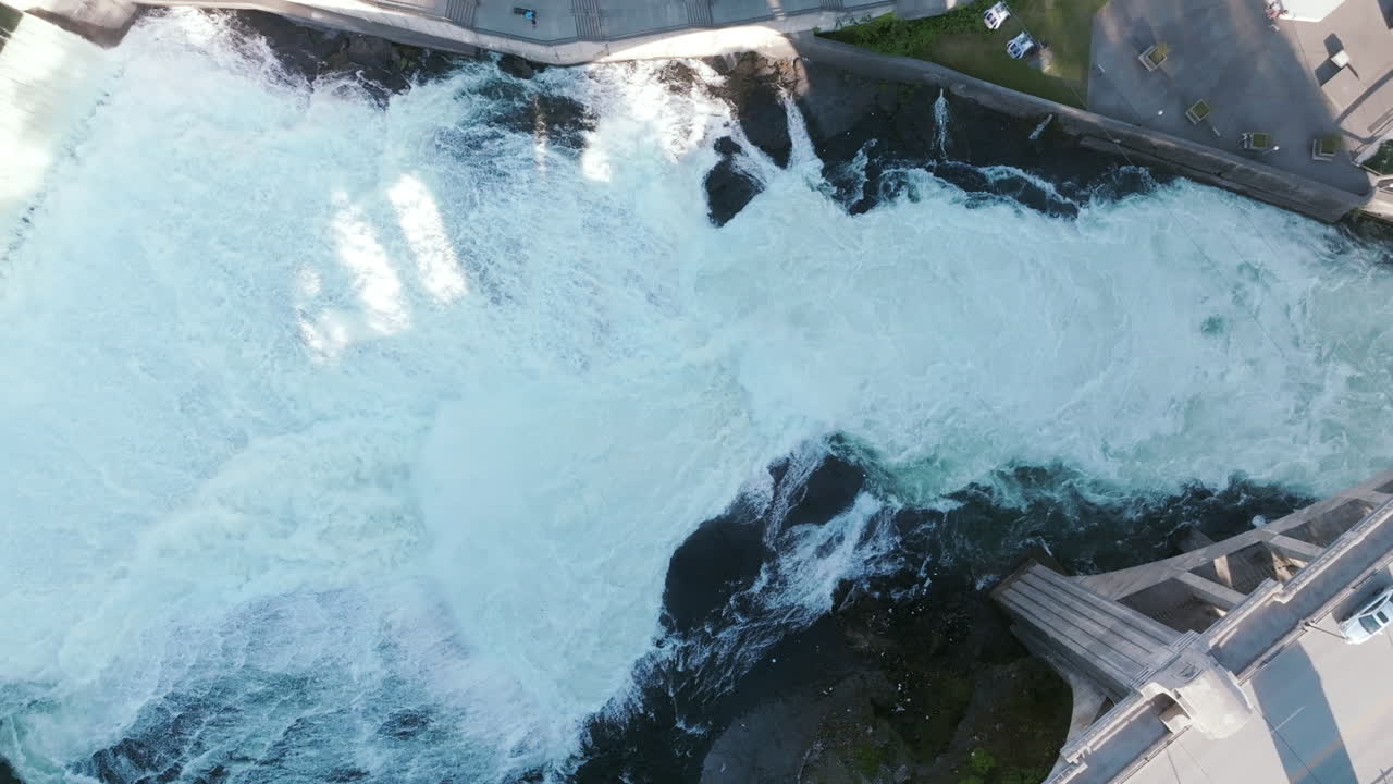 Whitewater crashes hard below the bridge. The water churns and foams in every direction