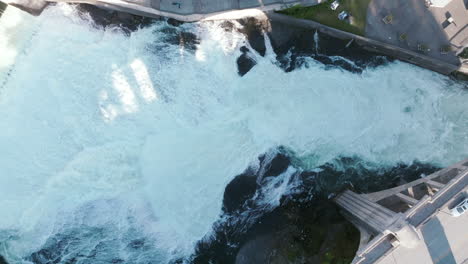 whitewater crashes hard below the bridge. the water churns and foams in every direction