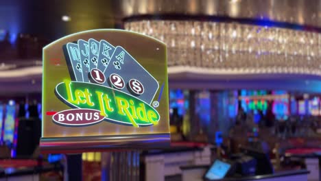 Let-it-Ride-Bonus-poker-card-table-sign-on-casino-floor,-static-view,-4K