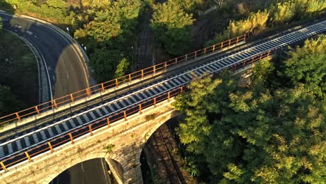 Rising-reveal-over-a-golden-sunset-through-countryside-and-train-tracks