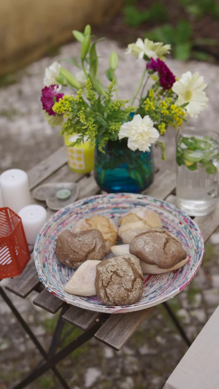 Outdoor patio dining with flowers and bread