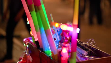 vibrant glow sticks displayed in a busy area