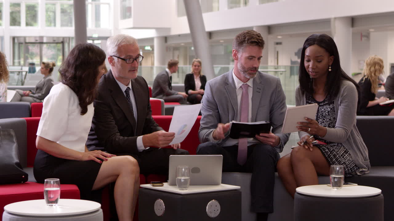 Businesspeople Meeting In Lobby Of Modern Office Shot On R3D