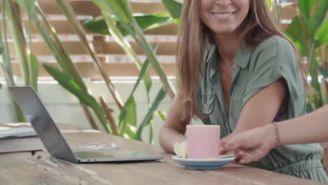 woman working in cafe outdoors