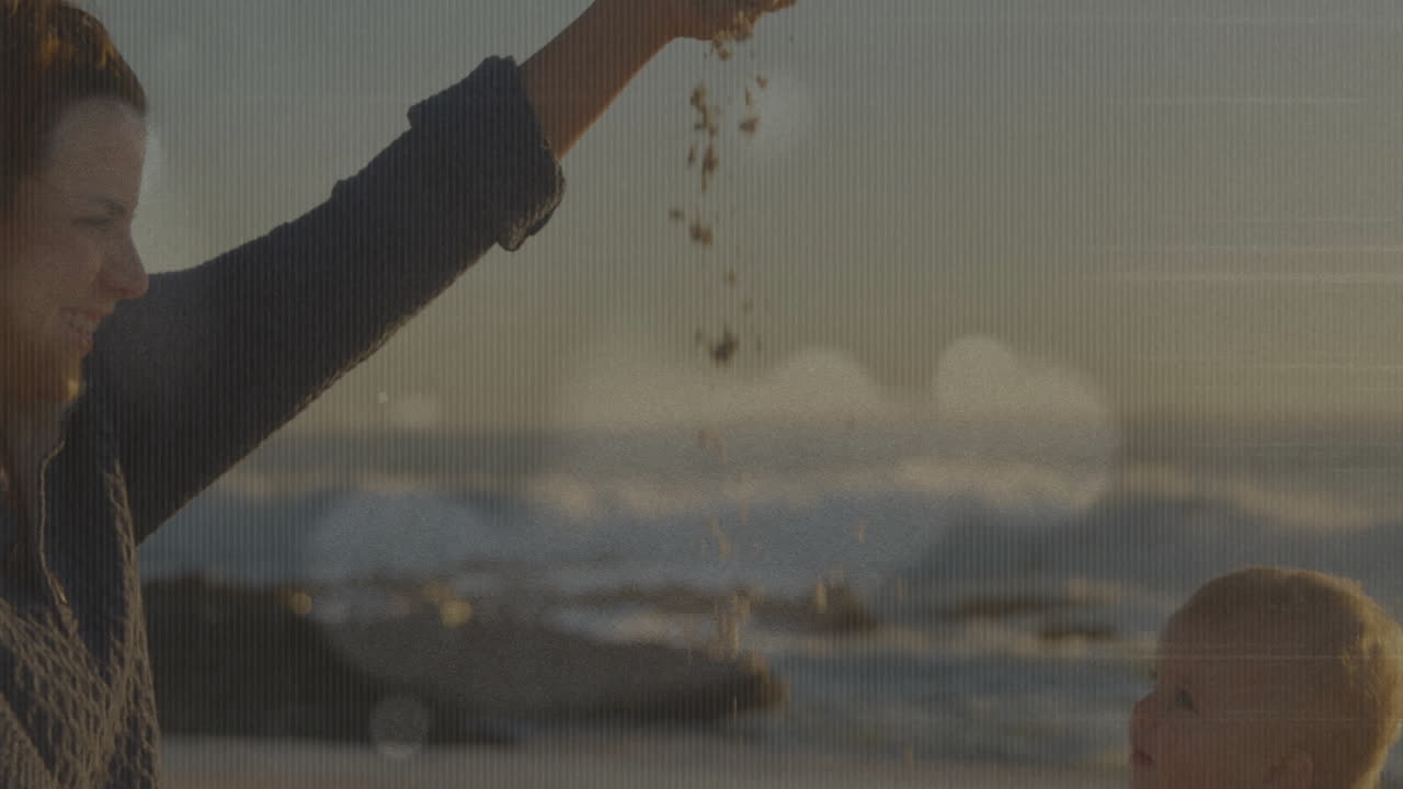 Holding sand, person letting it fall with ocean animation in background