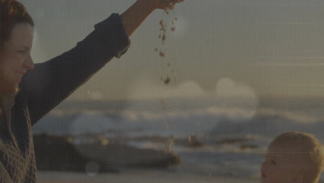 holding sand, person letting it fall with ocean animation in background