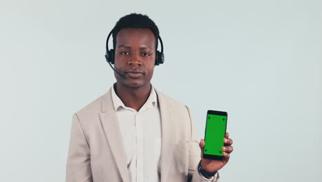 Man,-pointing-and-phone-in-call-center-with-green