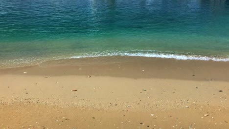 Waves-churn-up-the-sand-as-they-peacefully-roll-onto-shore-in-slow-motion