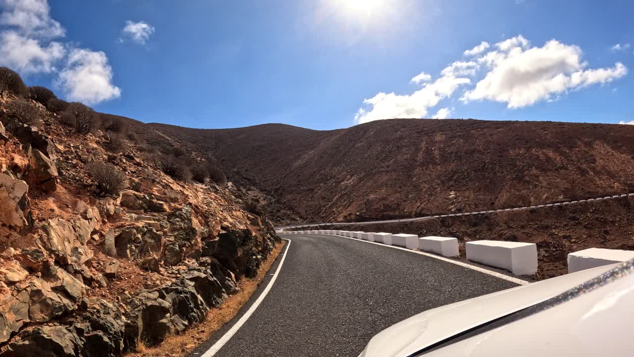 Immersive Car Interior POV Navigating Sharp Bends on a Rugged Mountain Road in the Arid Wilderness of Fuerteventura