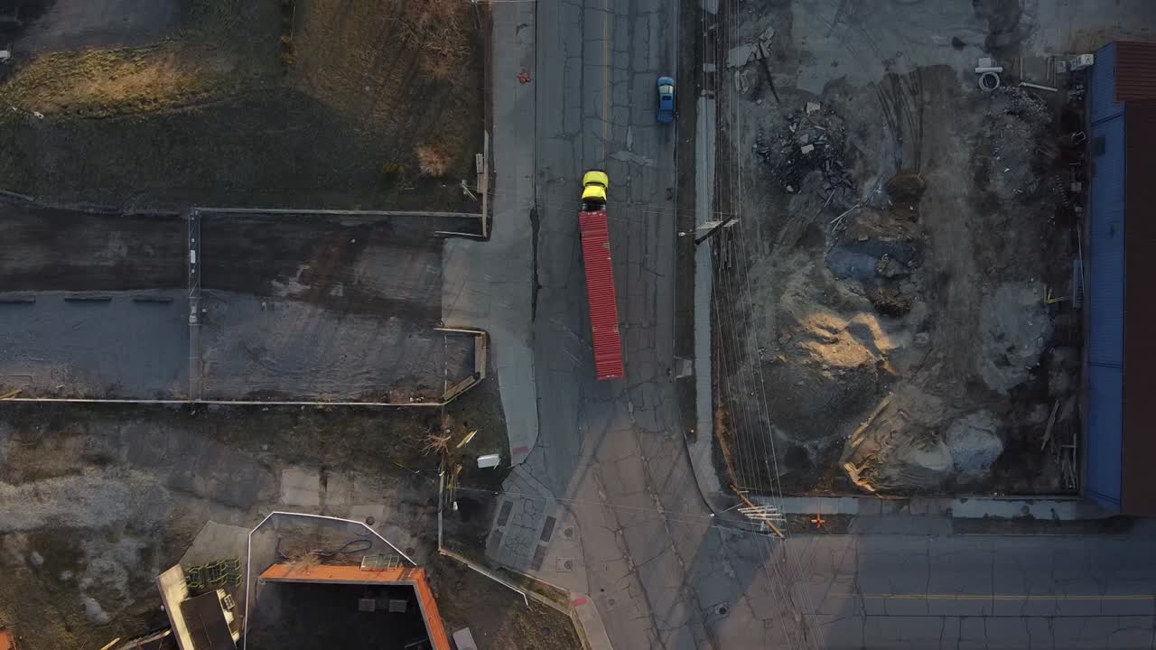 A Big Rig Semi Truck Turning On The Curve Road Inside The Industrial Area In Detroit, Michigan.-aerial shot