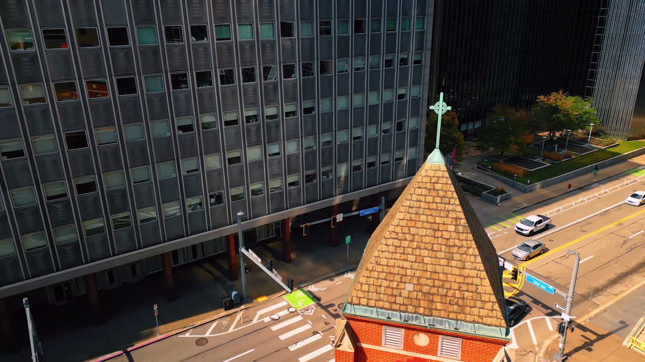 Pittsburgh, USA, 2 August 2025: Flight around the pyramid top of the church with cross. Aerial perspective on the street of Pittsburg, Pennsylvania, USA