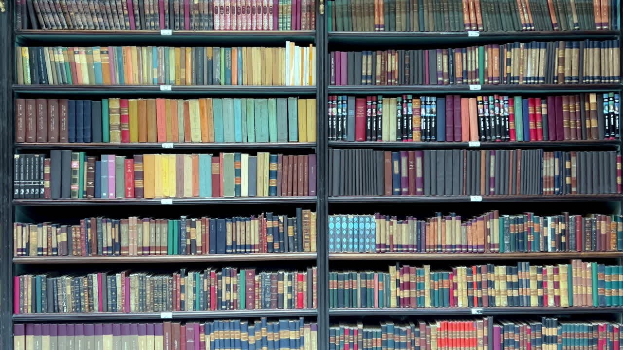 A close-up view of multiple tiers of historic bookshelves