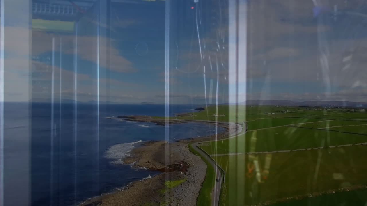 Digital data animation overlaying road and fields in coastal landscape scenery