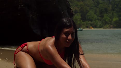 a young latin girl in a bikini, enjoying the tranquil and colorful scenery of a caribbean shore.