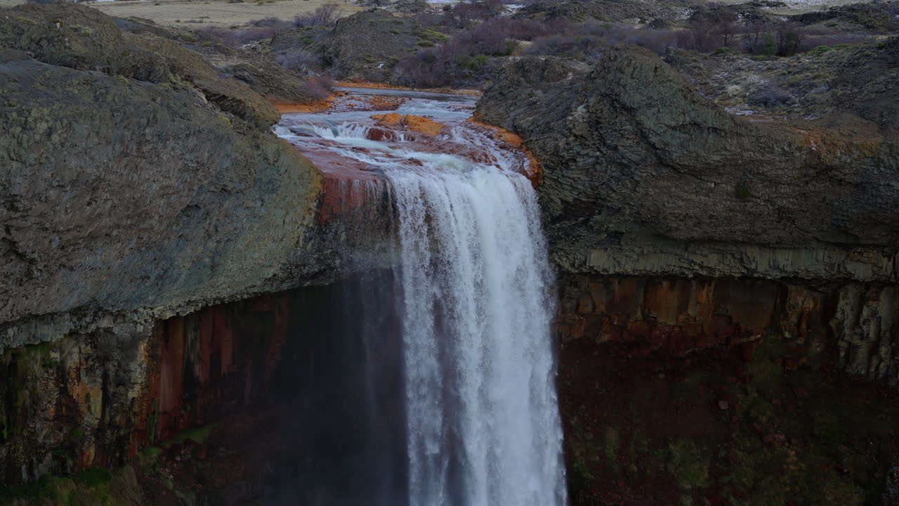 Vertical tilted down drone panoramic shot of the whole and cascading Salto del Agrio waterfall, Neuquén, Argentina