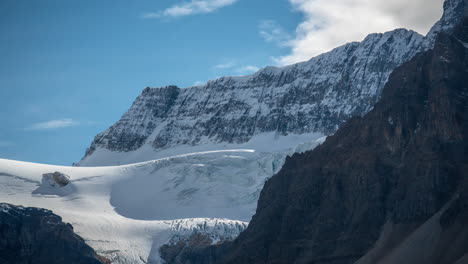 time lapse, snow and ice under cliff on sunny winter day, white winter landscape on high elevation